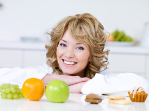 Woman with fruits and cakes